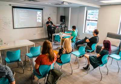 three students working together on the floor